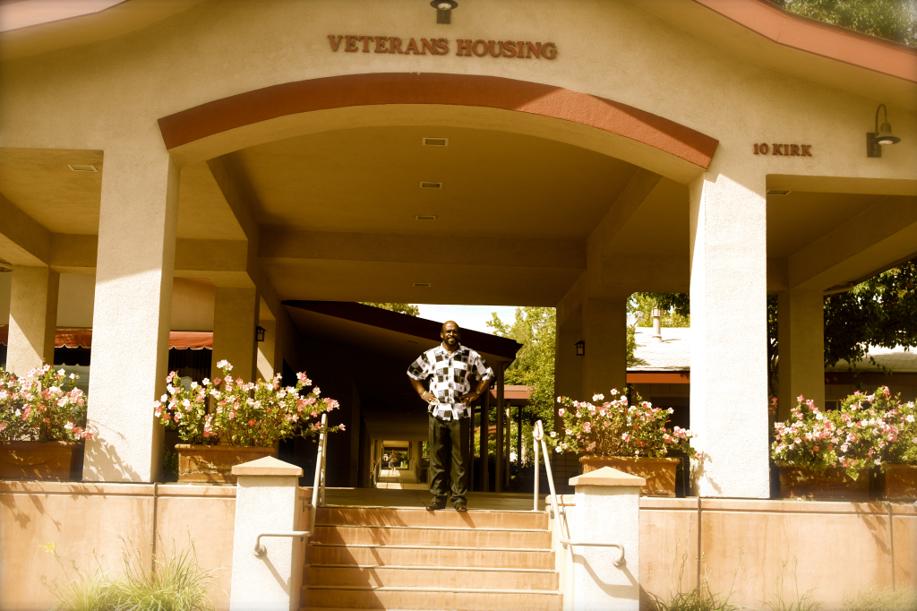 CEO & Founder Irvin Goodwin stands proudly beneath the archway entrance of our facility.